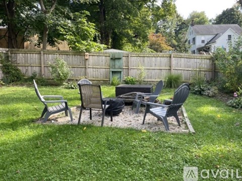 A backyard with a table and chairs set up.
