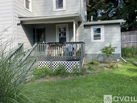 A house with a grey exterior and a white window.