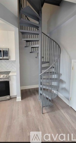A staircase with a metal railing and wooden steps.