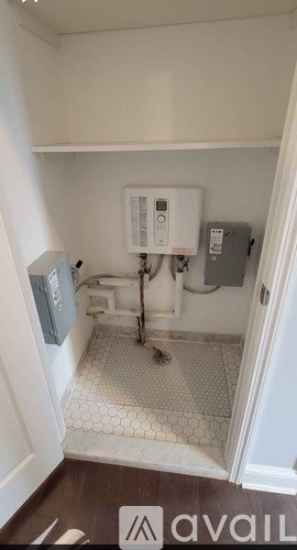 A small bathroom with a toilet, sink, and a white tiled floor.