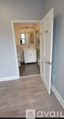 A bathroom with a white cabinet and a mirror is shown.