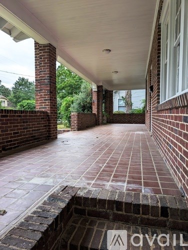 A patio with a brick wall and pillars.