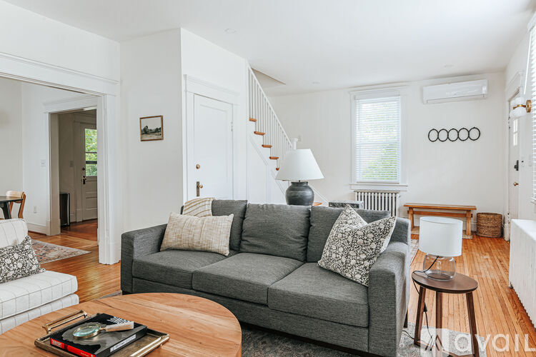 A living room with a grey couch and a coffee table.