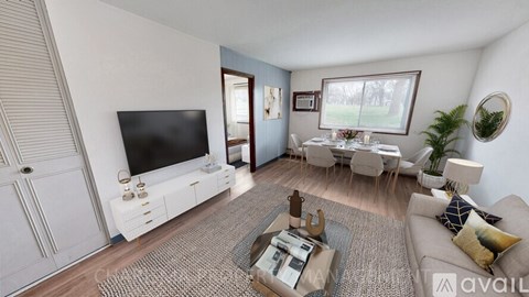 A living room with a television, sofa, and dining table.