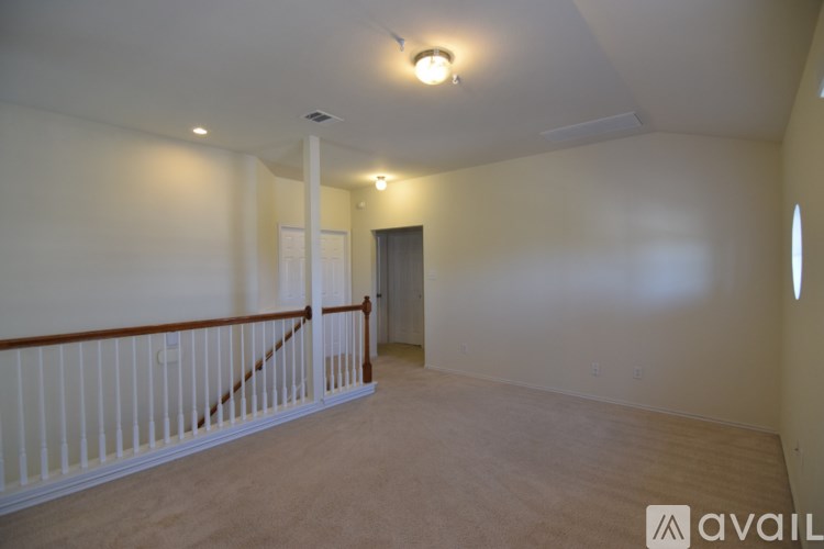 A room with a white wall and a wooden floor.