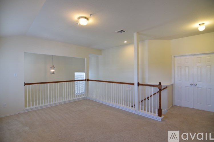 A spacious room with a balcony and a window.