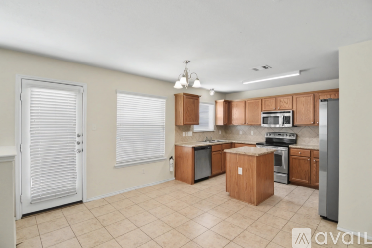 A kitchen with wooden cabinets and a refrigerator.
