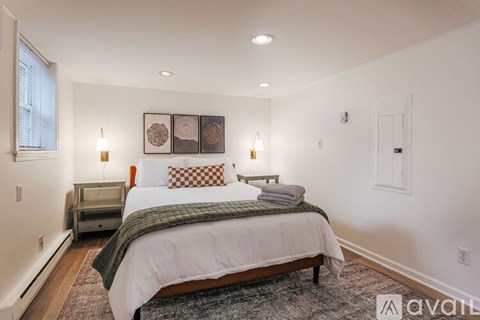 A bedroom with a large bed and a window.