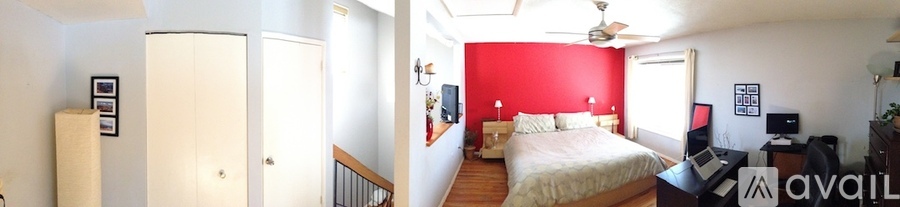 A room with carpeted floor and two windows.