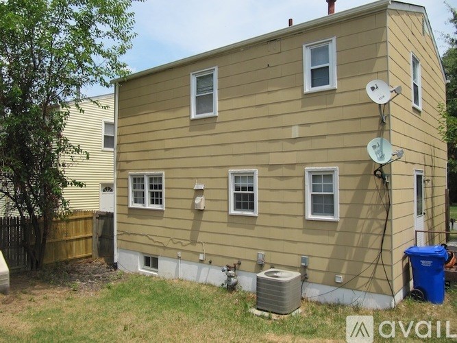 A house with a satellite dish on the roof.