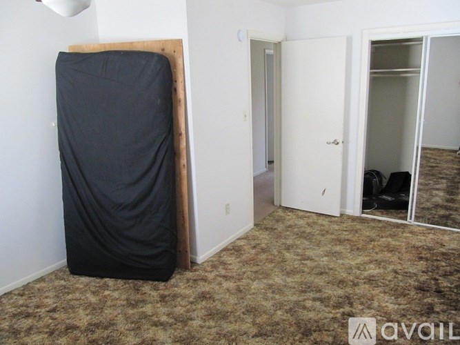 A room with a black cloth covering a large object.