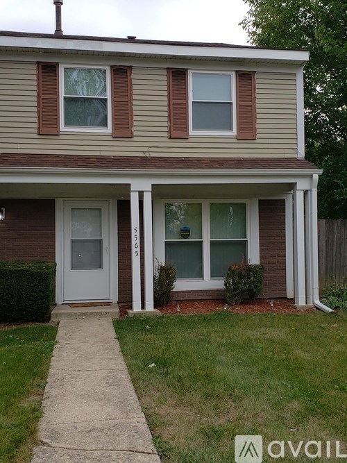 A house with a white door and a small porch.