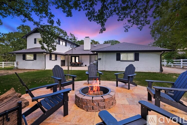 A house with a fire pit in front of it.