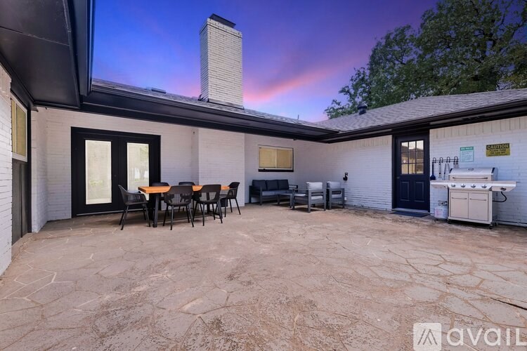A patio area with a table and chairs is available for rent.