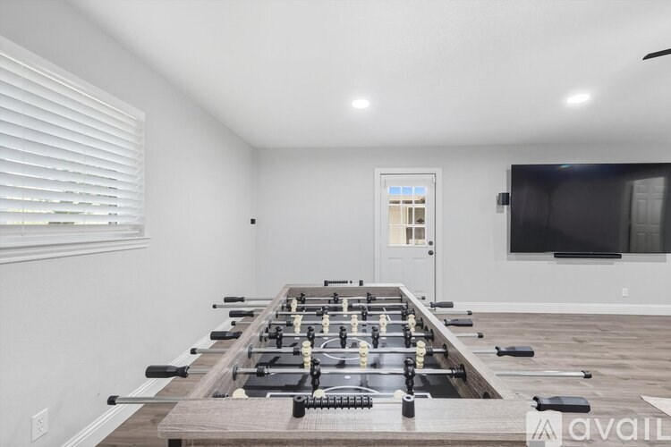 A room with a long row of exercise equipment.