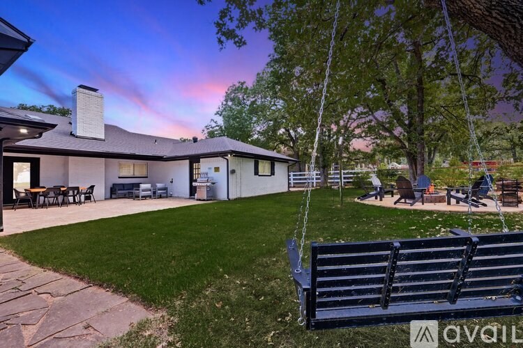 A house with a backyard and a swing set.