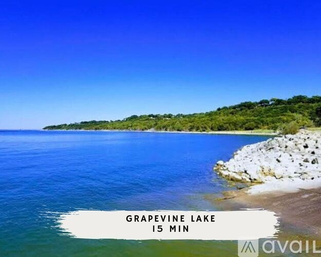 A beautiful lake with clear blue water and a rocky shore.