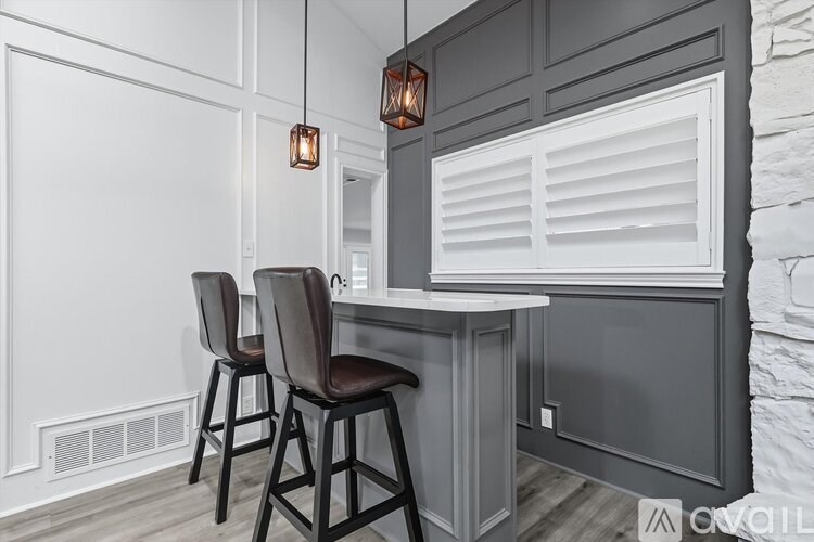 A kitchen with white walls and a grey counter.