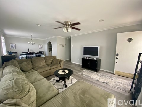 A living room with a large sectional sofa and a television.