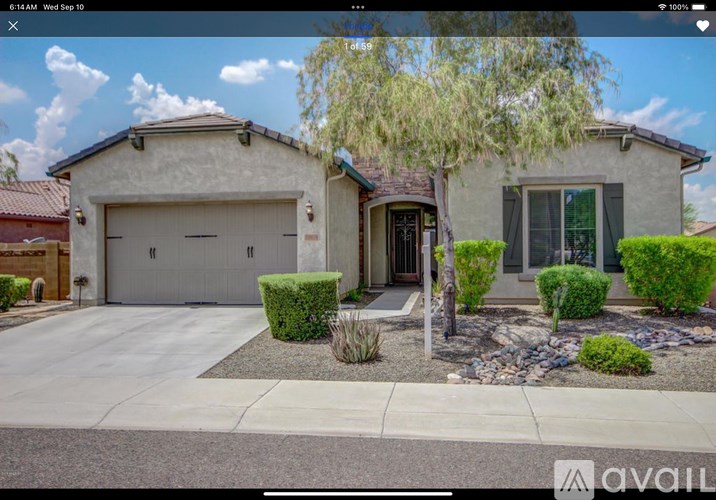A house with a garage and a driveway is displayed on a real estate website.