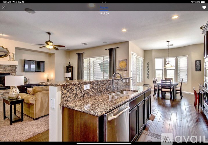 A modern kitchen with granite countertops and stainless steel appliances.