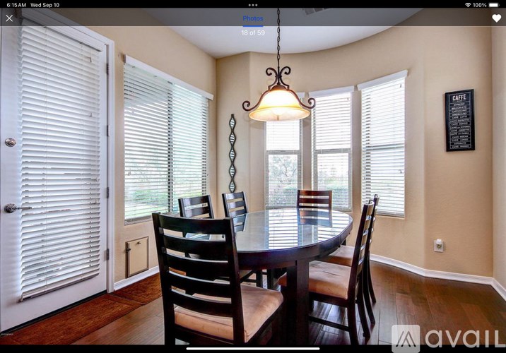A dining room with a table and chairs.