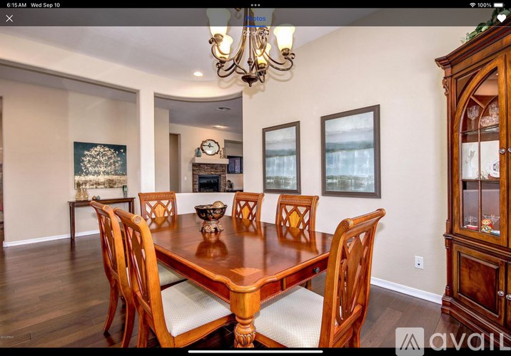A dining room with a wooden table and chairs.