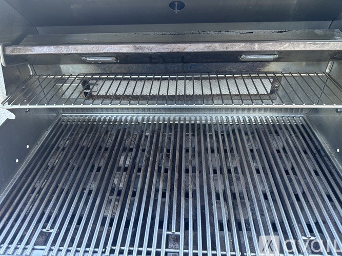 The image shows the interior of an oven with a focus on the racks and grates.