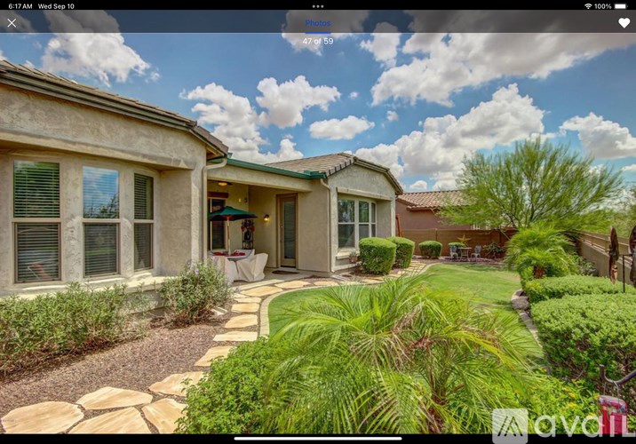 A house with a stone pathway leading to the front door.