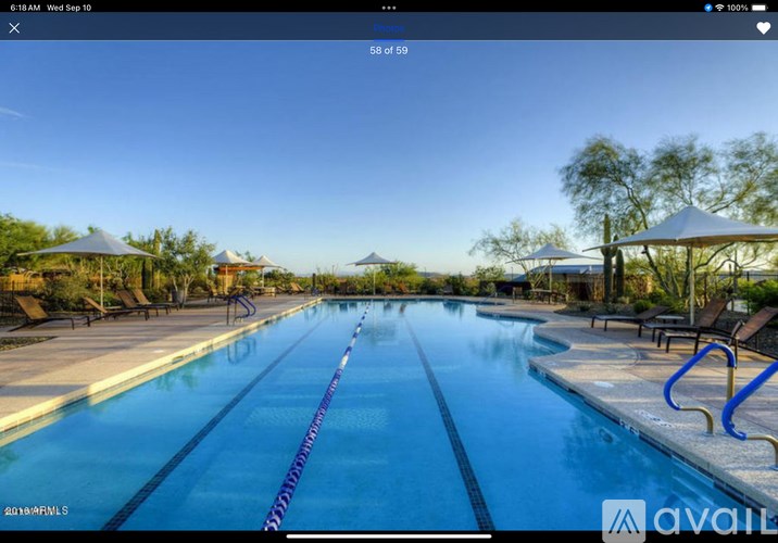 A large outdoor swimming pool with a blue line in the middle of it.
