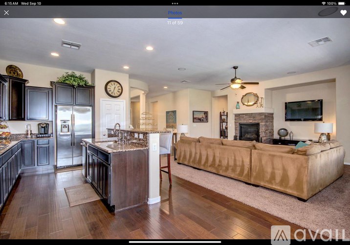A modern kitchen with dark wood cabinets and a central island.