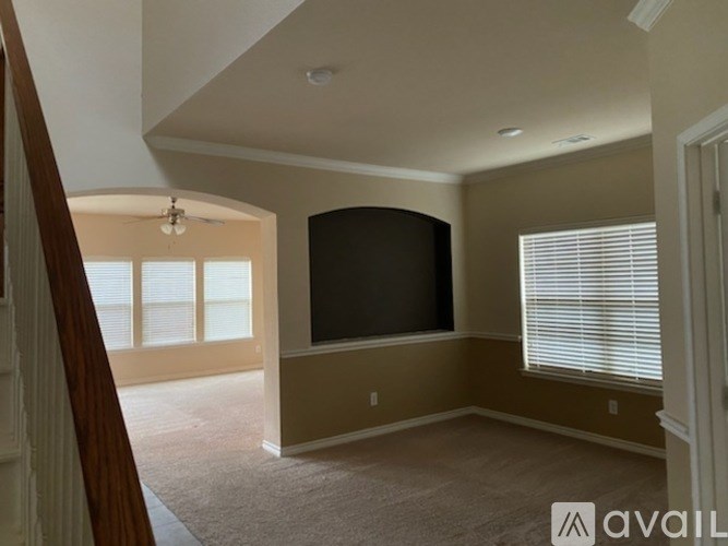 A living room with a flat screen TV mounted on the wall.