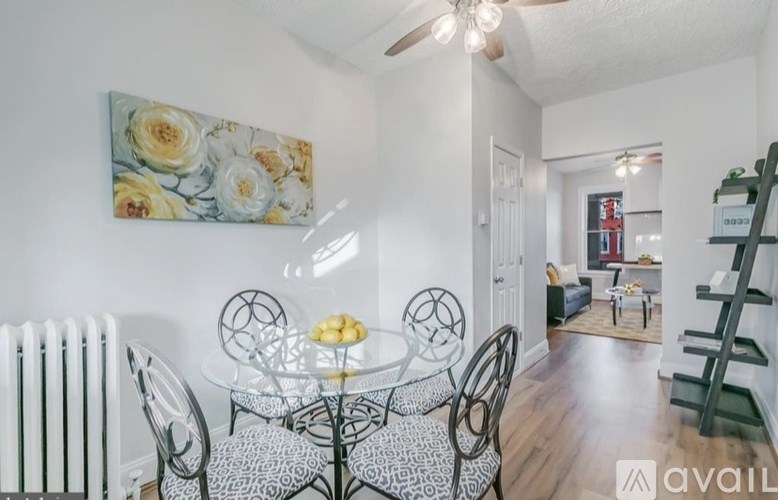 A dining room with a glass table and chairs.