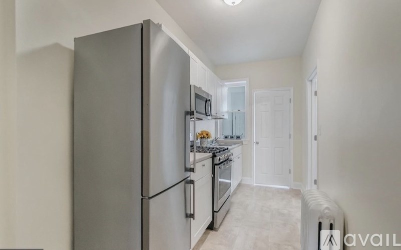 A kitchen with a refrigerator, microwave, and stove.