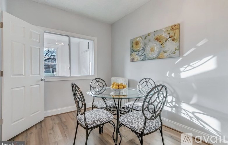 A dining room with a glass table and chairs.