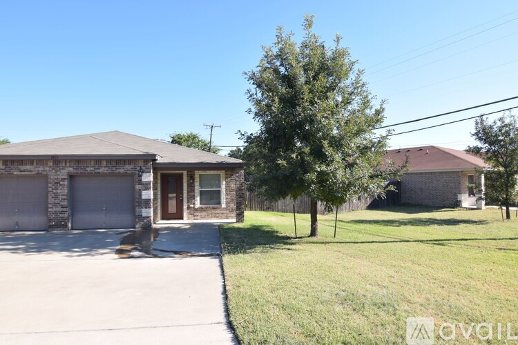 A house with a tree in front of it.