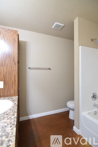 A bathroom with a toilet, sink, and bathtub.