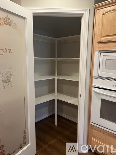 A white fridge with a glass door is in a kitchen.