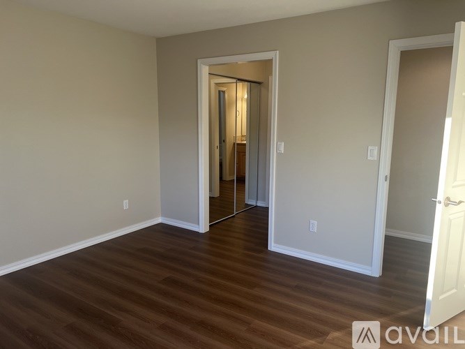 A room with wooden floors and a white door.
