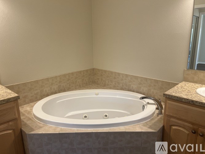 A bathroom with a jacuzzi tub in the middle.