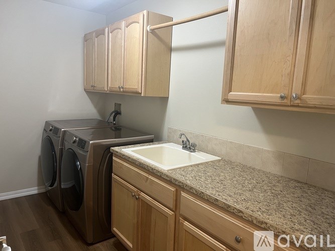 A kitchen with wooden cabinets and a granite countertop.
