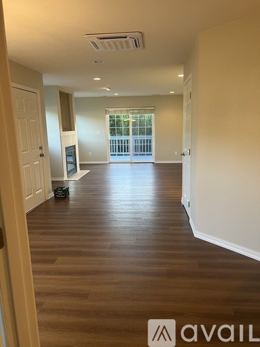 A room with wooden floors and white walls.