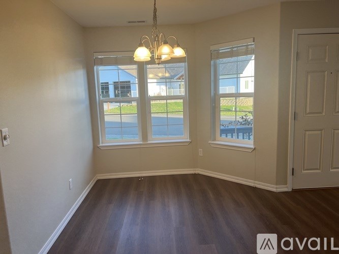 A room with a large window and a door.