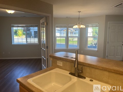 A kitchen with a sink and a window.