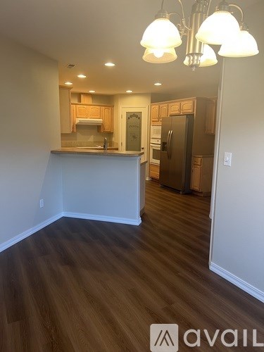 A kitchen with wooden floors and a counter.