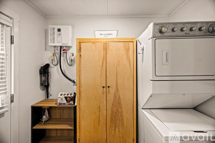 A kitchen with a wooden door and a stove.