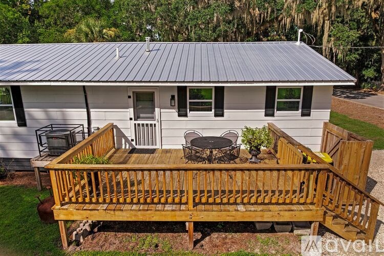 A house with a metal roof and a wooden deck.