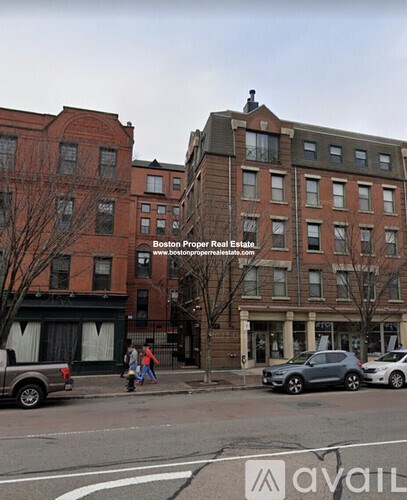 A street view of a building with a sign that says "Boston Property Real Estate.".