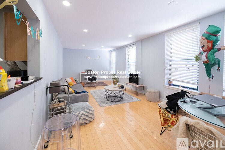 A living room with a glass table and a sofa.
