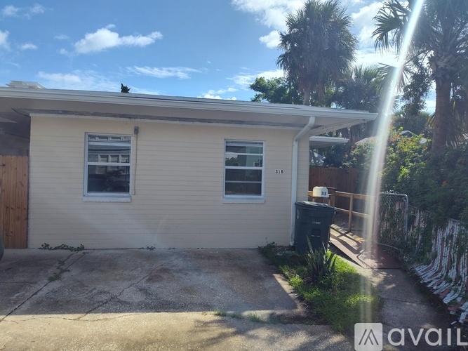 A house with a brown door and a window is for sale.